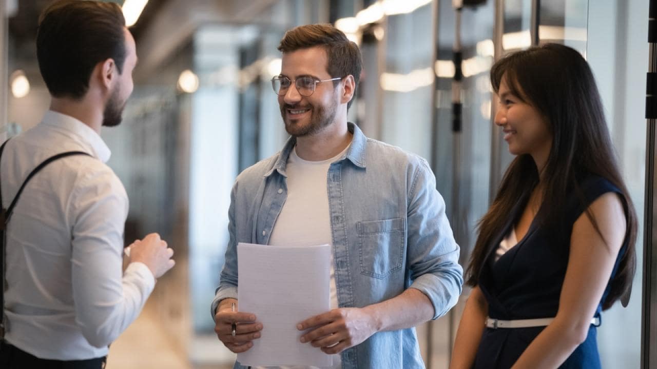 smiling-diverse-colleagues-talking