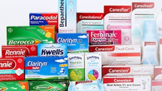 A variety of health products, including medications and supplements, are displayed in their packaging.